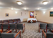 Thumbnail 11 of 14 - a conference room with chairs and a table with a cross on the wall