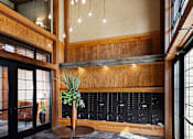 Thumbnail 24 of 53 - the lobby of a building with a plant in a vase