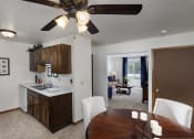 Thumbnail 30 of 31 - a kitchen and dining room with a table and a ceiling fan