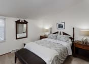 Thumbnail 31 of 31 - a bedroom with a large bed and a mirror on the wall
