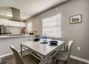 Thumbnail 5 of 47 - a dining area with a table and chairs and a kitchen