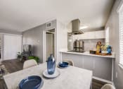Thumbnail 12 of 47 - a kitchen and dining room with a table and chairs