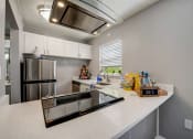 Thumbnail 7 of 47 - the kitchen is equipped with stainless steel appliances and white countertops