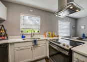 Thumbnail 6 of 47 - a kitchen with a sink and a stove and a window