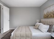 Thumbnail 63 of 66 - A bedroom with a large bed and a painting on the wall.