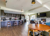 Thumbnail 95 of 124 - A modern kitchen with a wooden table and chairs.