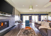 Thumbnail 96 of 124 - A living room with a fireplace and a couch.
