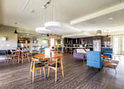 Thumbnail 99 of 124 - A modern dining room with a wooden table and chairs.