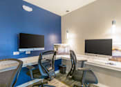 Thumbnail 74 of 124 - A room with two computer monitors and chairs.