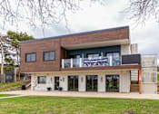 Thumbnail 119 of 124 - A modern house with a large glass window and a sign that says "Welcome Home".