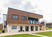 Thumbnail 121 of 124 - A modern building with a brown and white exterior.