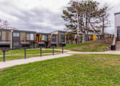 Thumbnail 114 of 124 - A series of modern townhouses with a grassy front yard.