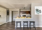 Thumbnail 68 of 124 - A kitchen with a bar stool in front of a counter.