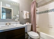 Thumbnail 45 of 124 - A bathroom with a white sink and a white toilet.