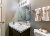 Thumbnail 47 of 124 - A bathroom with a white sink and a mirror above it.