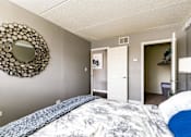 Thumbnail 28 of 124 - A bedroom with a bed and a mirror on the wall.