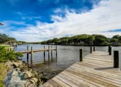 Thumbnail 22 of 47 - a dock on a body of water with trees
