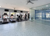 Thumbnail 25 of 35 - A gym with treadmills, exercise bikes, and a glass wall.
