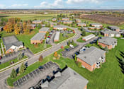 Thumbnail 74 of 77 - A large building complex with a parking lot in front. at CenterPointe Apartments & Townhomes, Canandaigua, NY