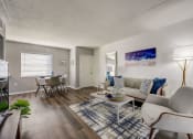Thumbnail 1 of 47 - a living room with a couch and chairs and a dining room table