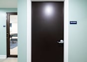 Thumbnail 26 of 27 - A black door with a sign that says "dog wash" on the wall.