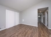 Thumbnail 4 of 50 - an empty living room with wood flooring and white walls at Centerpointe Apartments, New York, 14424
