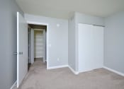 Thumbnail 11 of 50 - an empty room with a closet and a door to a bathroom  at Centerpointe Apartments, New York, 14424