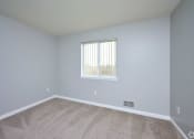 Thumbnail 18 of 50 - an empty room with carpet and a window at Centerpointe Apartments, Canandaigua, New York