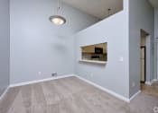 Thumbnail 16 of 50 - an empty living room with a white wall and carpet and a ceiling light at Centerpointe Apartments, Canandaigua, NY, 14424