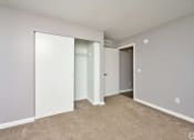 Thumbnail 17 of 50 - an empty room with white walls and a door to a closet at Centerpointe Apartments, Canandaigua