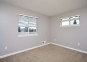 Thumbnail 24 of 50 - an empty bedroom with two windows and carpeting at Centerpointe Apartments, New York, 14424
