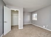 Thumbnail 22 of 50 - an empty bedroom with a closet and a door to a bathroom at Centerpointe Apartments, New York, 14424