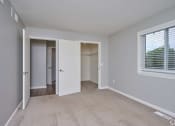 Thumbnail 23 of 50 - an empty bedroom with a closet and a window at Centerpointe Apartments, Canandaigua, New York