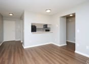 Thumbnail 6 of 50 - an empty living room with a hard wood floor and a kitchen at Centerpointe Apartments, New York