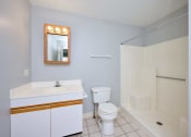 Thumbnail 27 of 50 - a bathroom with a toilet sink and a shower at Centerpointe Apartments, New York