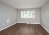 Thumbnail 28 of 50 - an empty room with wood floors and a window at Centerpointe Apartments, Canandaigua, NY