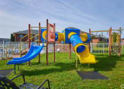 Thumbnail 35 of 50 - a playground with slides and other toys in a park at Centerpointe Apartments, New York
