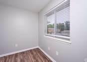 Thumbnail 21 of 50 - an empty room with a large window and wood floors at Centerpointe Apartments, Canandaigua, NY, 14424