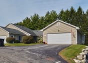 Thumbnail 41 of 50 - a house with a driveway and a white garage door at Centerpointe Apartments, Canandaigua, NY