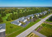 Thumbnail 45 of 50 - an aerial view of a neighborhood of houses with green grass and trees at Centerpointe Apartments, New York