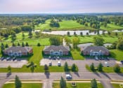 Thumbnail 42 of 50 - an aerial view of a neighborhood of houses with cars parked in front of a field at Centerpointe Apartments, New York, 14424