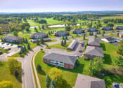 Thumbnail 43 of 50 - an aerial view of a neighborhood of houses and yards with green grass and trees at Centerpointe Apartments, Canandaigua