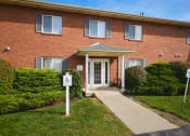 Thumbnail 49 of 50 - the front of a brick building with a walkway in front of the front door at Centerpointe Apartments, New York
