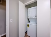 Thumbnail 3 of 50 - a small laundry room with a washer and dryer in it at Centerpointe Apartments, Canandaigua, New York