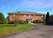 Thumbnail 50 of 50 - a large brick house with a driveway in front of it at Centerpointe Apartments, Canandaigua, NY, 14424