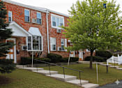 Thumbnail 3 of 35 - A red brick building with a tree in front of it.