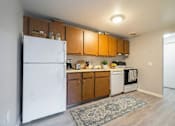 Thumbnail 12 of 66 - A kitchen with wooden cabinets and a white refrigerator. at Willowbrooke Apartments & Townhomes, Brockport, NY, 14420