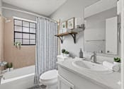 Thumbnail 13 of 42 - A bathroom with a white sink, toilet, and a shower with a glass door. at The Flats at Seminole Heights, Florida, 33603