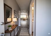 Thumbnail 41 of 66 - A hallway with a lamp and a plant on a table. at Willowbrooke Apartments & Townhomes, Brockport, 14420