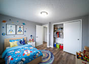 Thumbnail 22 of 35 - A child's bedroom with a rocket-themed bed and a toy storage area.